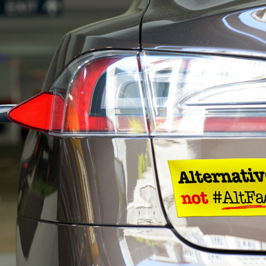 SFE bumper sticker on an electric vehicle receiving a charge